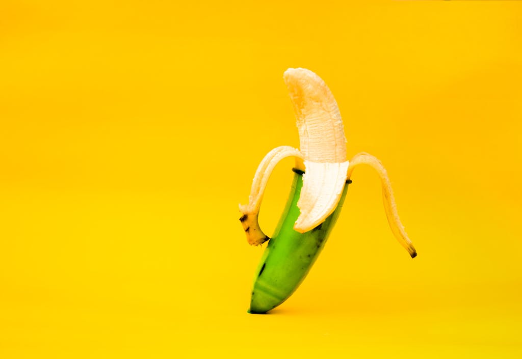 Abstract image of a banana with unique green and yellow tones on a vibrant backdrop.